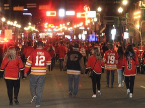 Calgary Flames fans celebrate a win over the Dallas Stars in Game 5 of the Stanley Cup playoffs along the Red Mile. Wednesday, May 11, 2022.